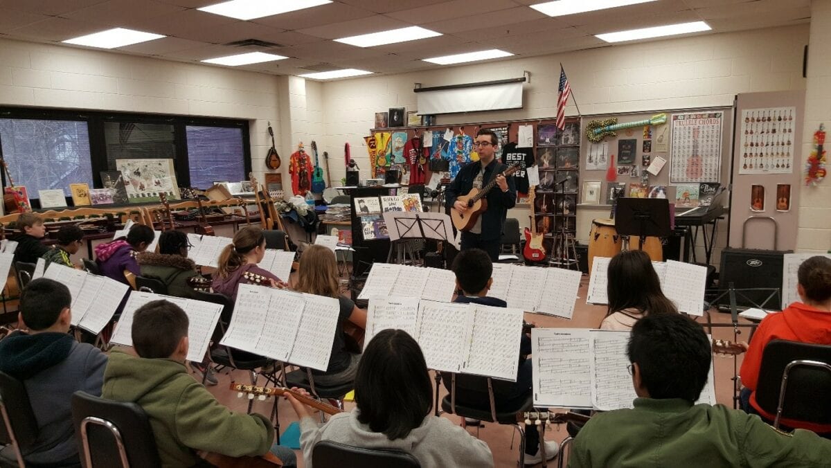 Mark Juliano teaching guitar in classroom