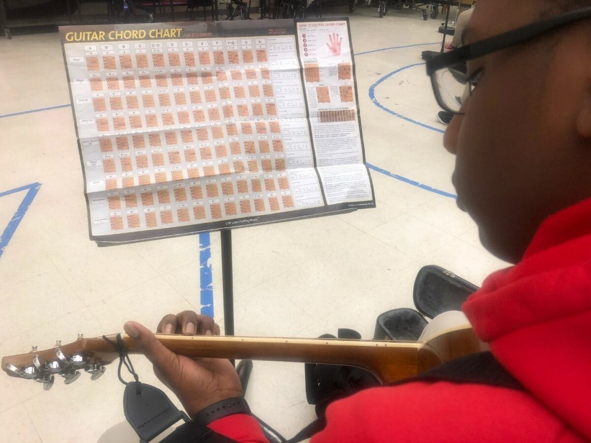 guitar student with music stand
