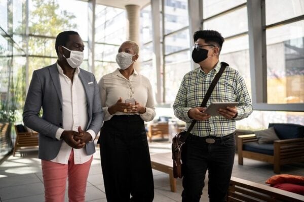 coworkers wearing face masks walking together