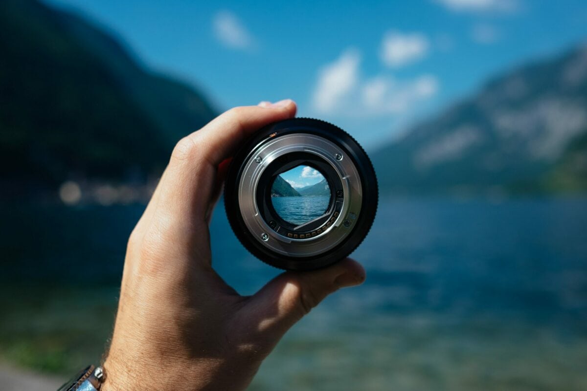 close up photo of a hand holding a camera lens