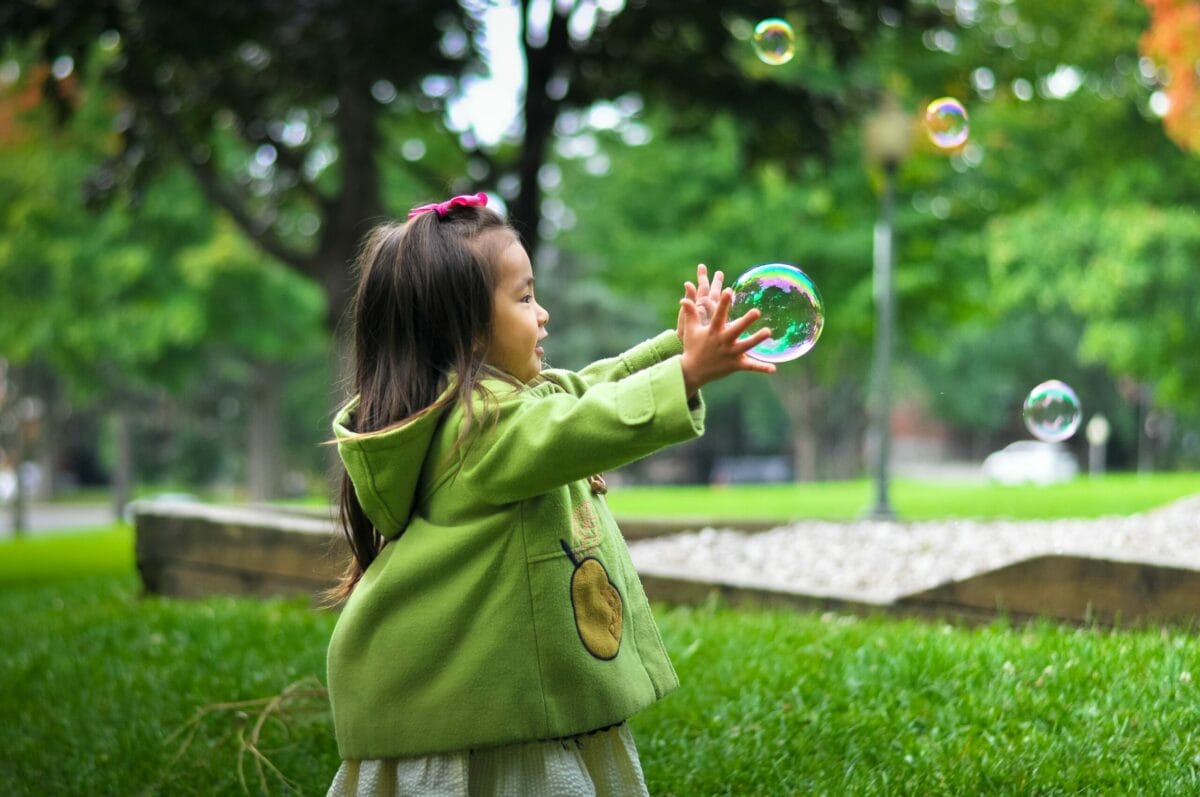 authentic experiences girl reaching for bubble