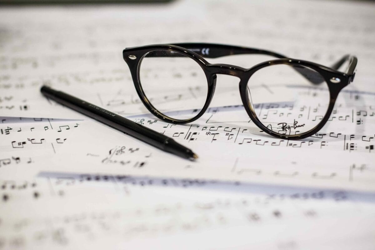 glasses and pen on sheet music