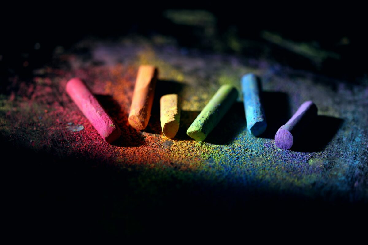 multicolored chalk on dark background