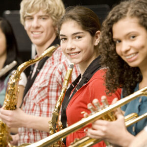 Teenage students holding saxophones