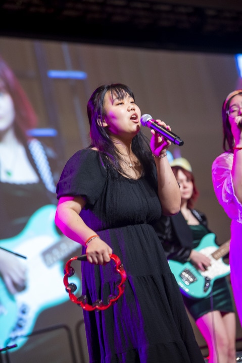 high school student singer with tambourine