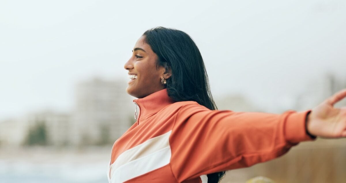smiling woman with arms outstretched