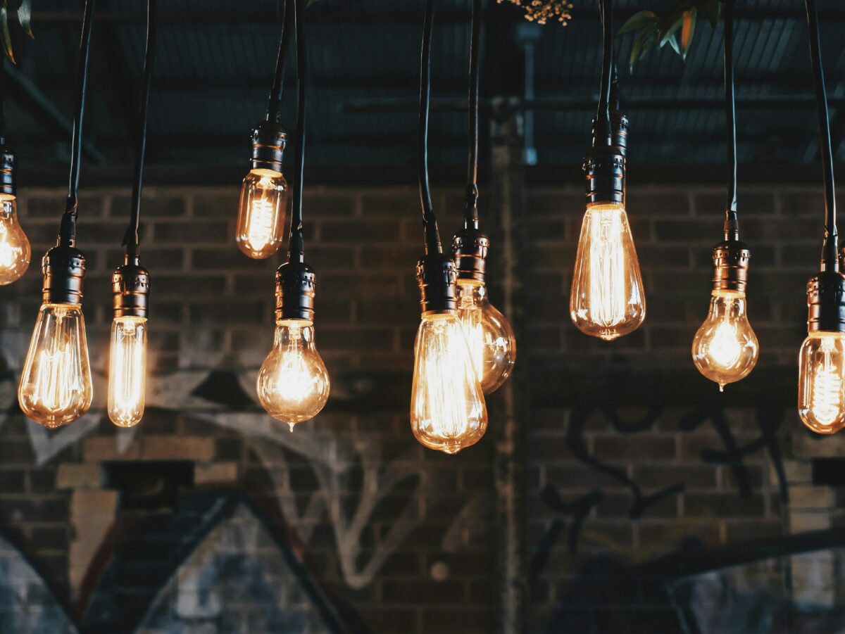 multiple Edison light bulbs hanging from ceiling and turned on