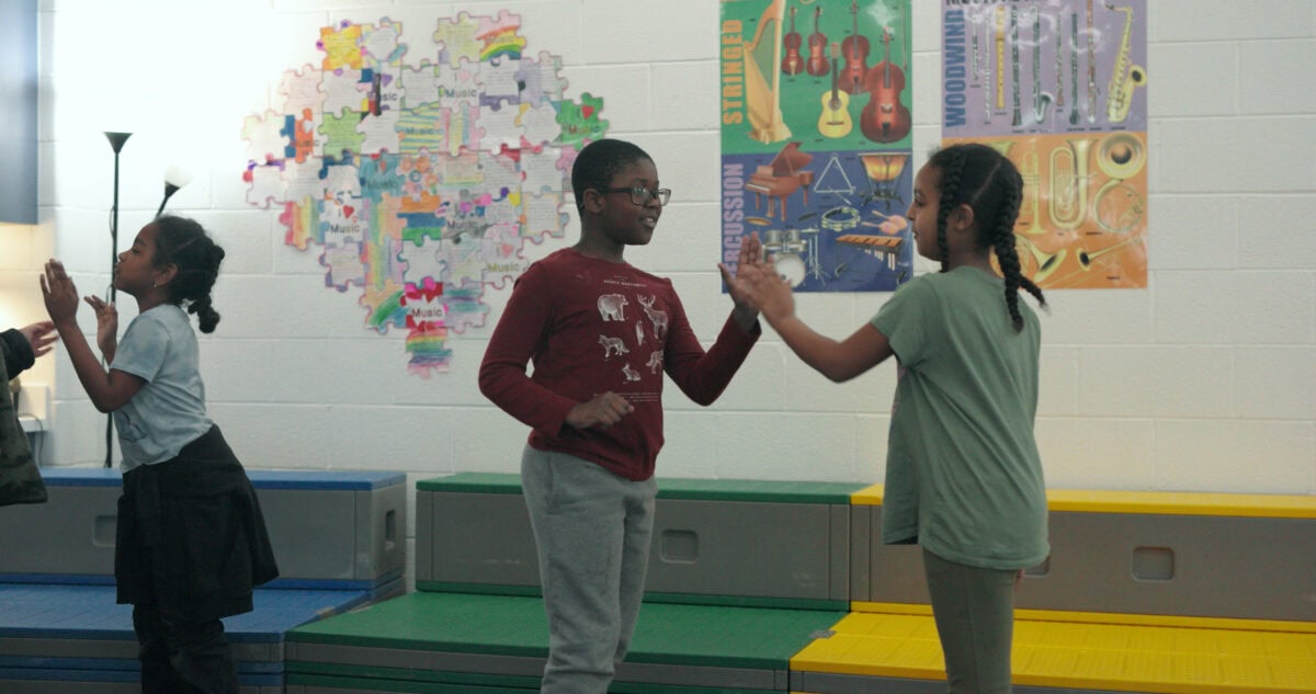elementary students dancing and singing
