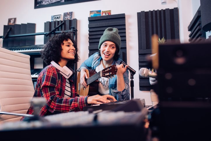 Young women making music in studio and having fun