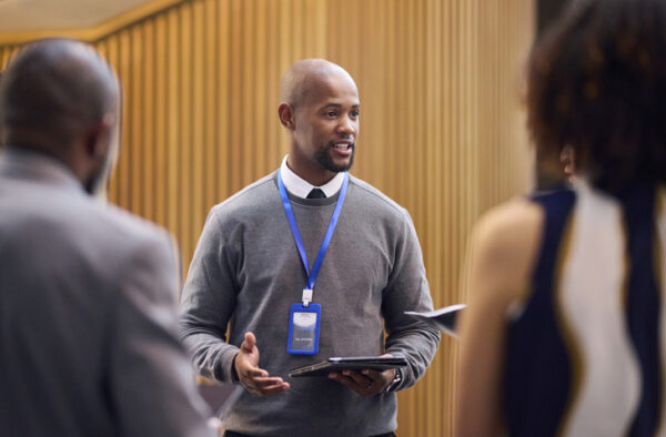 new teachers, administrators in discussion in performance hall