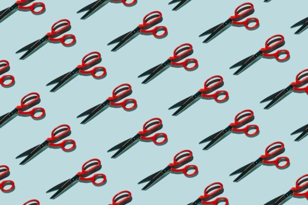 red scissors pattern against light blue background