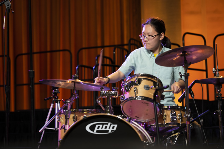 young Asian female drummer