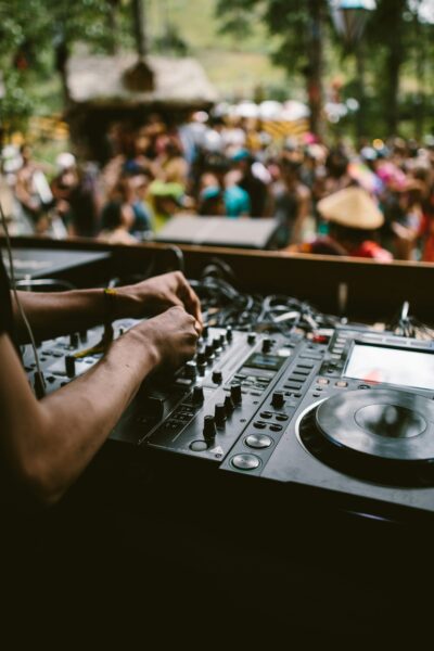 detail of DJ on equipment in front of audience