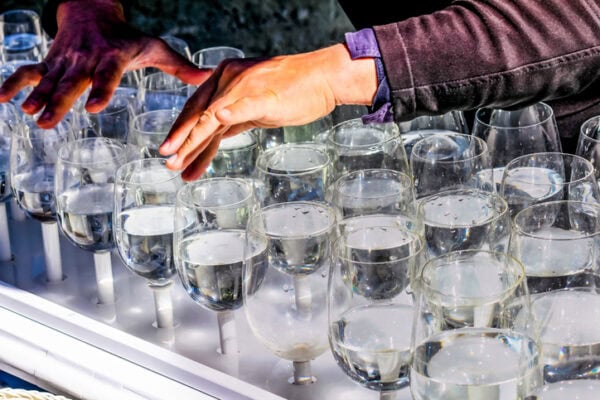 street artist plays full glasses of water and creates melodies 