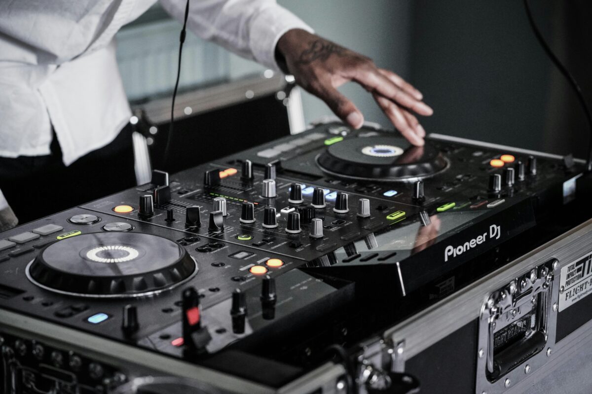 DJ operating black terminal mixer