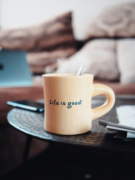 coffee mug labeled with Life is Good on a living room coffee table