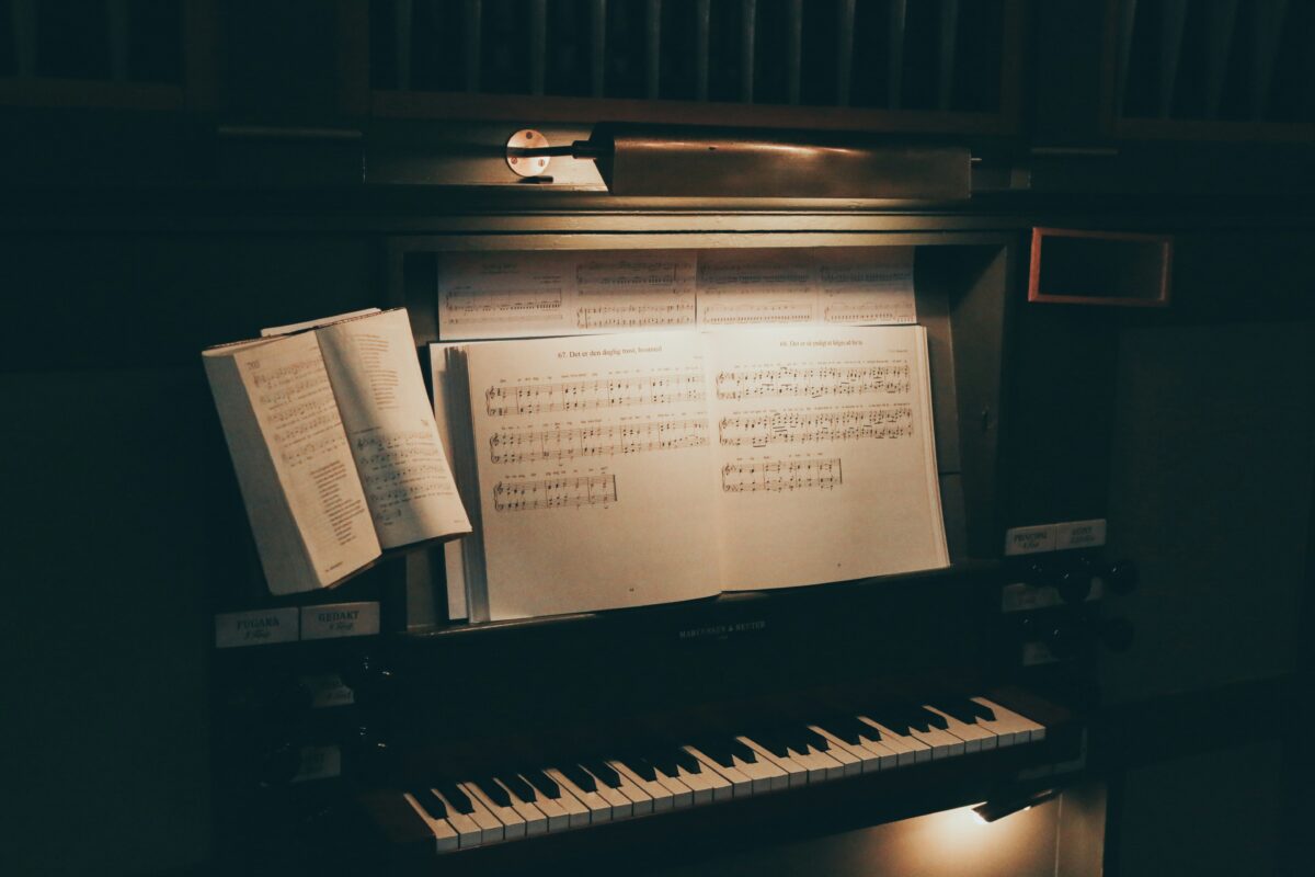 keyboard and sheet music in dimmed lighting