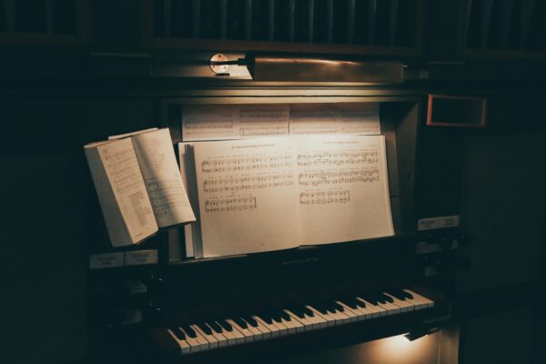 keyboard and sheet music in dimmed lighting