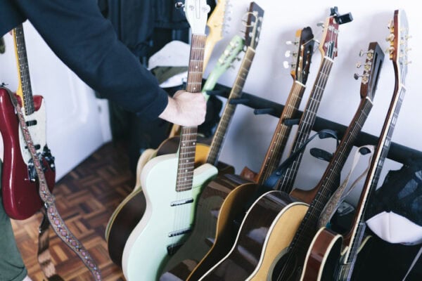 Man holding guitar at studio