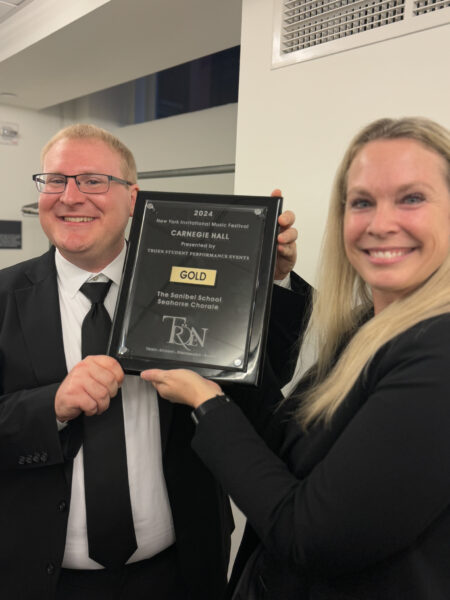 The Sanibel School Music Director Joey Giangreco (L) and Principal Jennifer Lusk (R) holding our recognition plaque after receiving a rating of Gold for our performance at Carnegie Hall