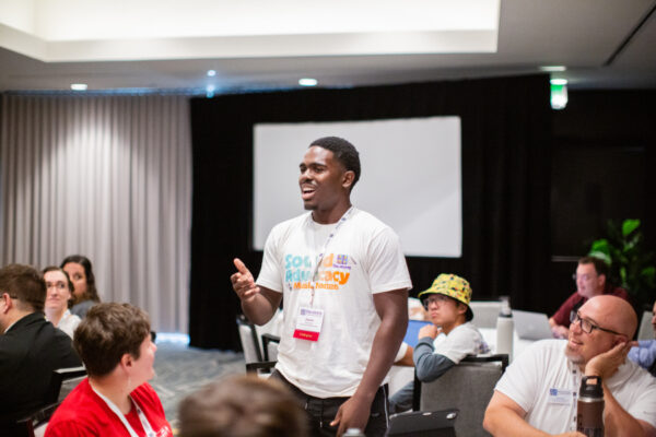 2025 Collegiate Leadership Advocacy Summit attendee standing and speaking