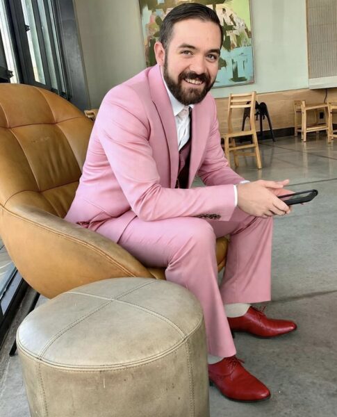 Jesse Tillman Pitts headshot wearing pink suit and red shoes