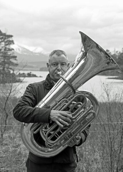 black and white photo of Mark Reynolds with tuba