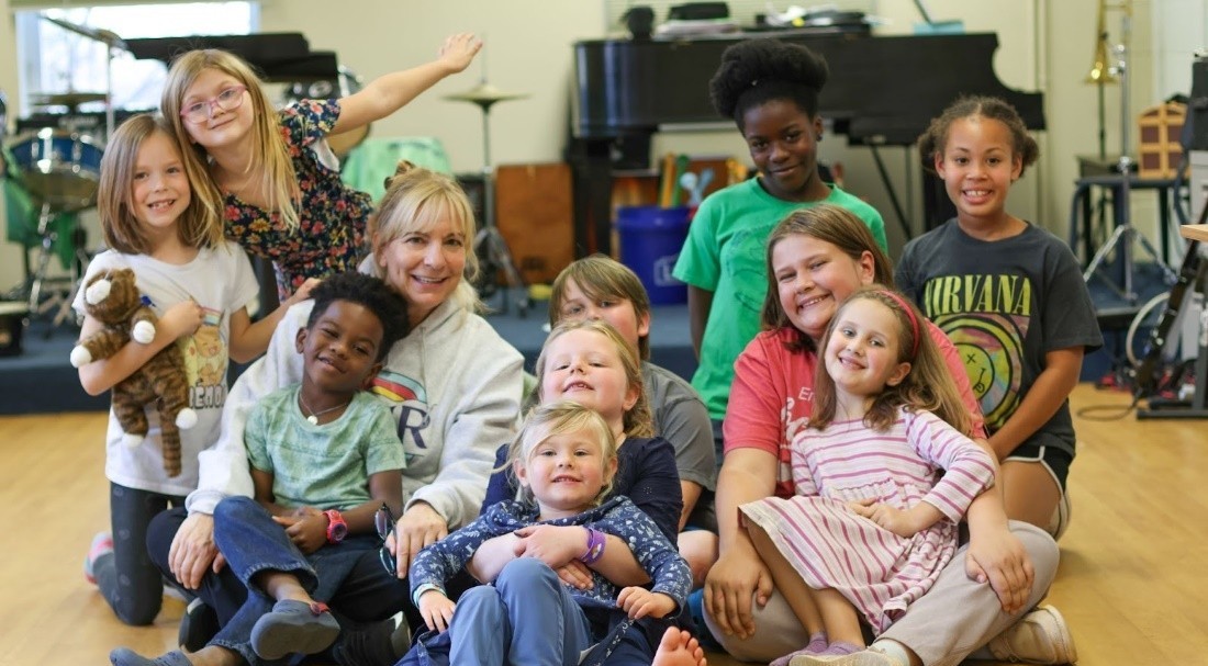 group of elementary students in classroom with Angela Kelly