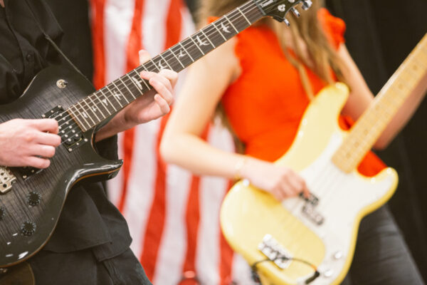 closeup of students playing electric guitars