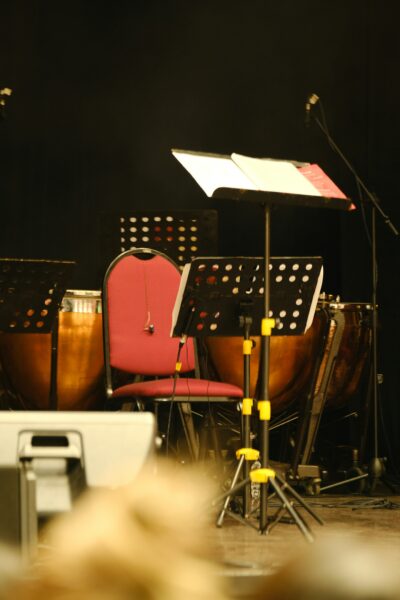 red chair and music stand on stage