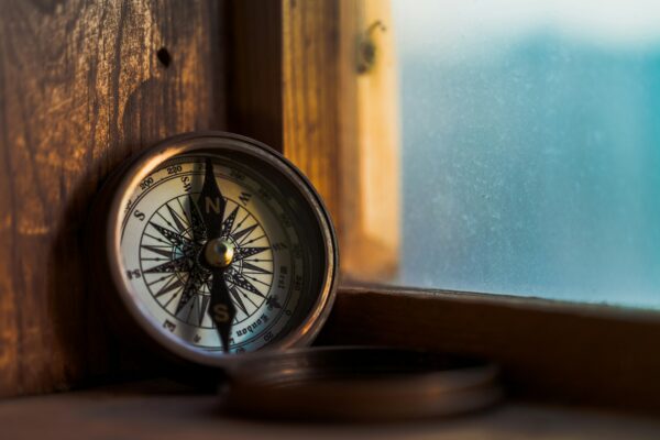 old compass in a window