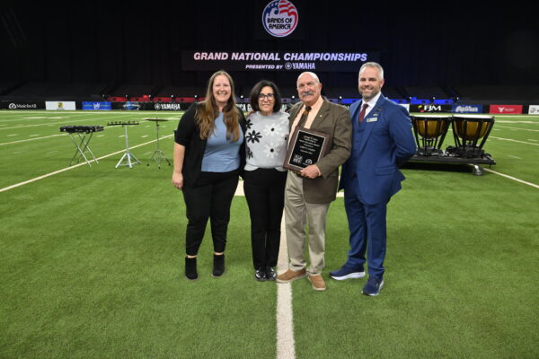 Left to right: Katherine Prihoda, NAfME Council for Band Education Co-Chair and North Central Division Representative; Dena and Gary Gilroy; and Dr. James Weaver, Music for All CEO and President.