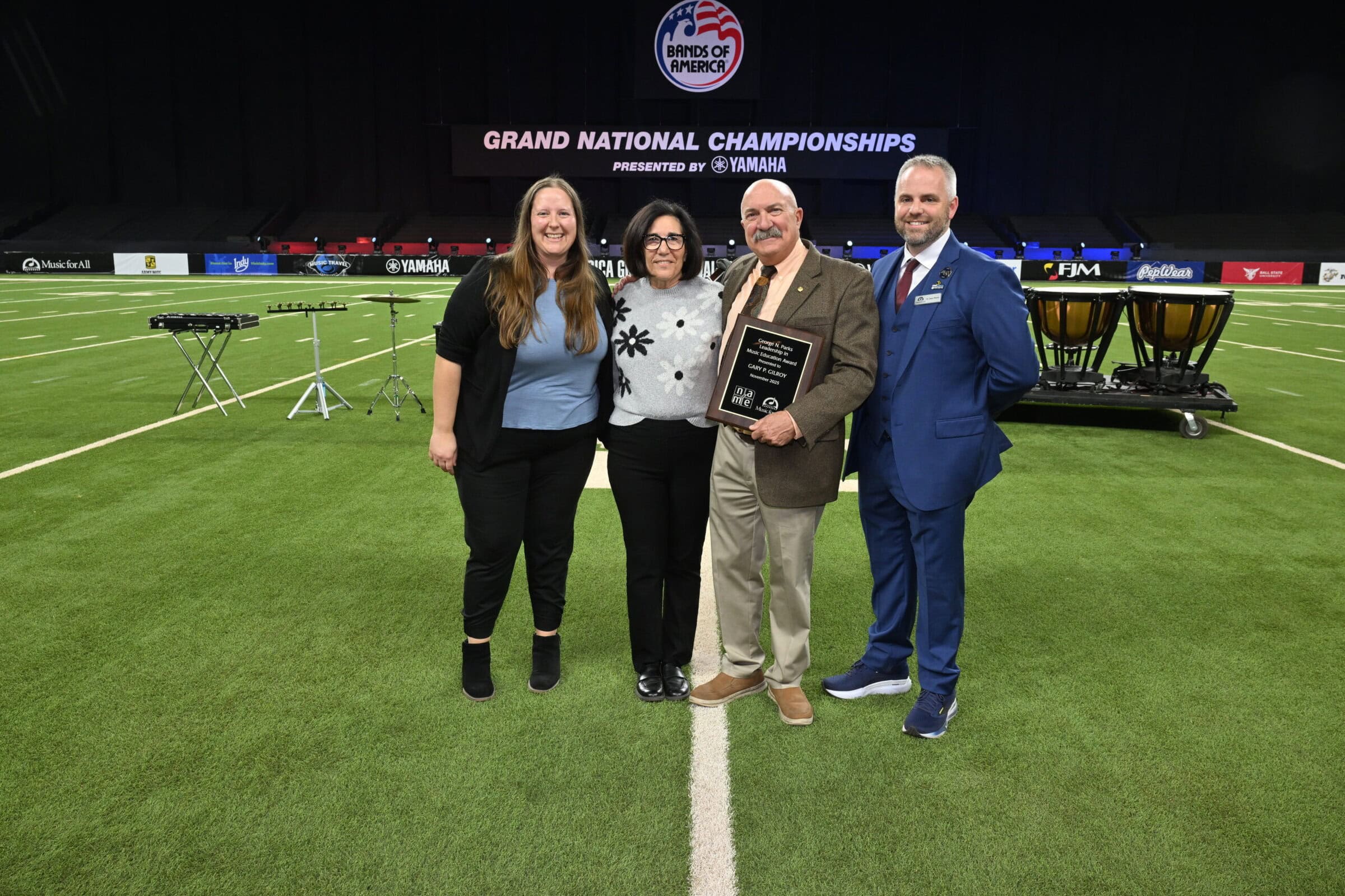 Left to right: Katherine Prihoda, NAfME Council for Band Education Co-Chair and North Central Division Representative; Dena and Gary Gilroy; and Dr. James Weaver, Music for All CEO and President.