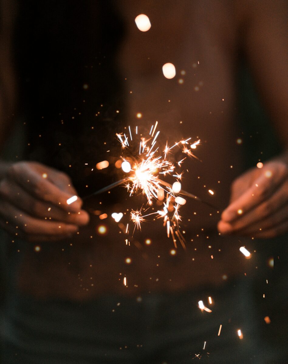 closeup of hands holding sparklers