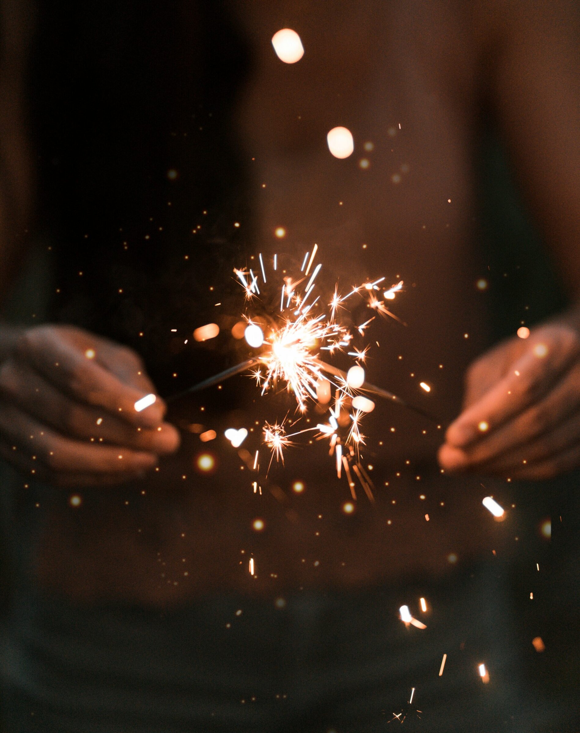 closeup of hands holding sparklers