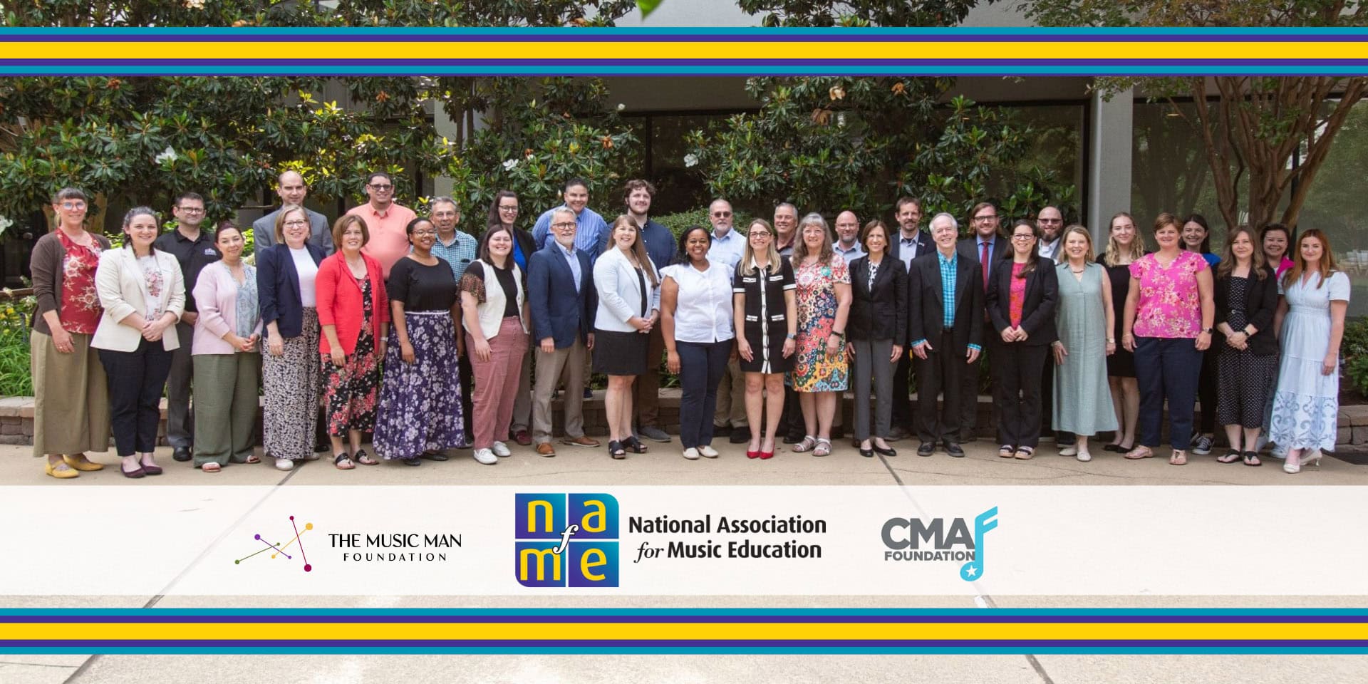 Group photo of the Advocacy Leadership Force standing together in a plaza surrounded by greenery