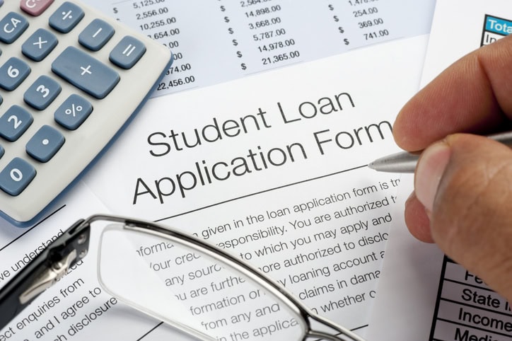 closeup of student loan application and calculator