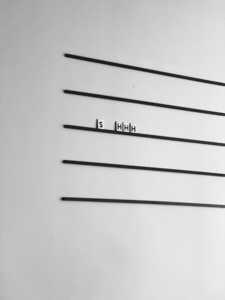 word Shhh on third line of music staff on white background