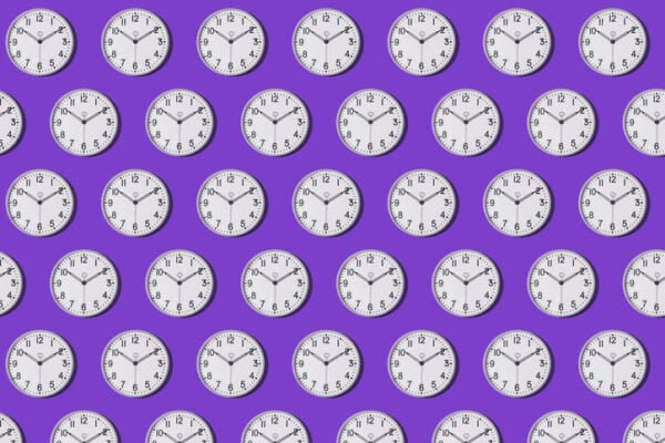 Pattern of wall clocks marking 10:10 on a purple background.