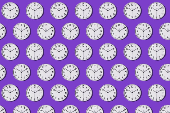 Pattern of wall clocks marking 10:10 on a purple background.