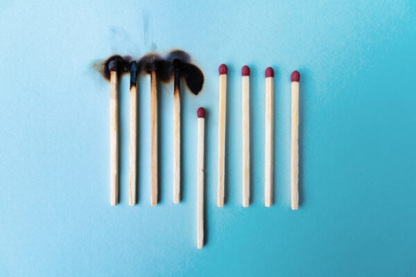 four burned matches with fifth match out of line and unburnt, remaining four matches not burnt