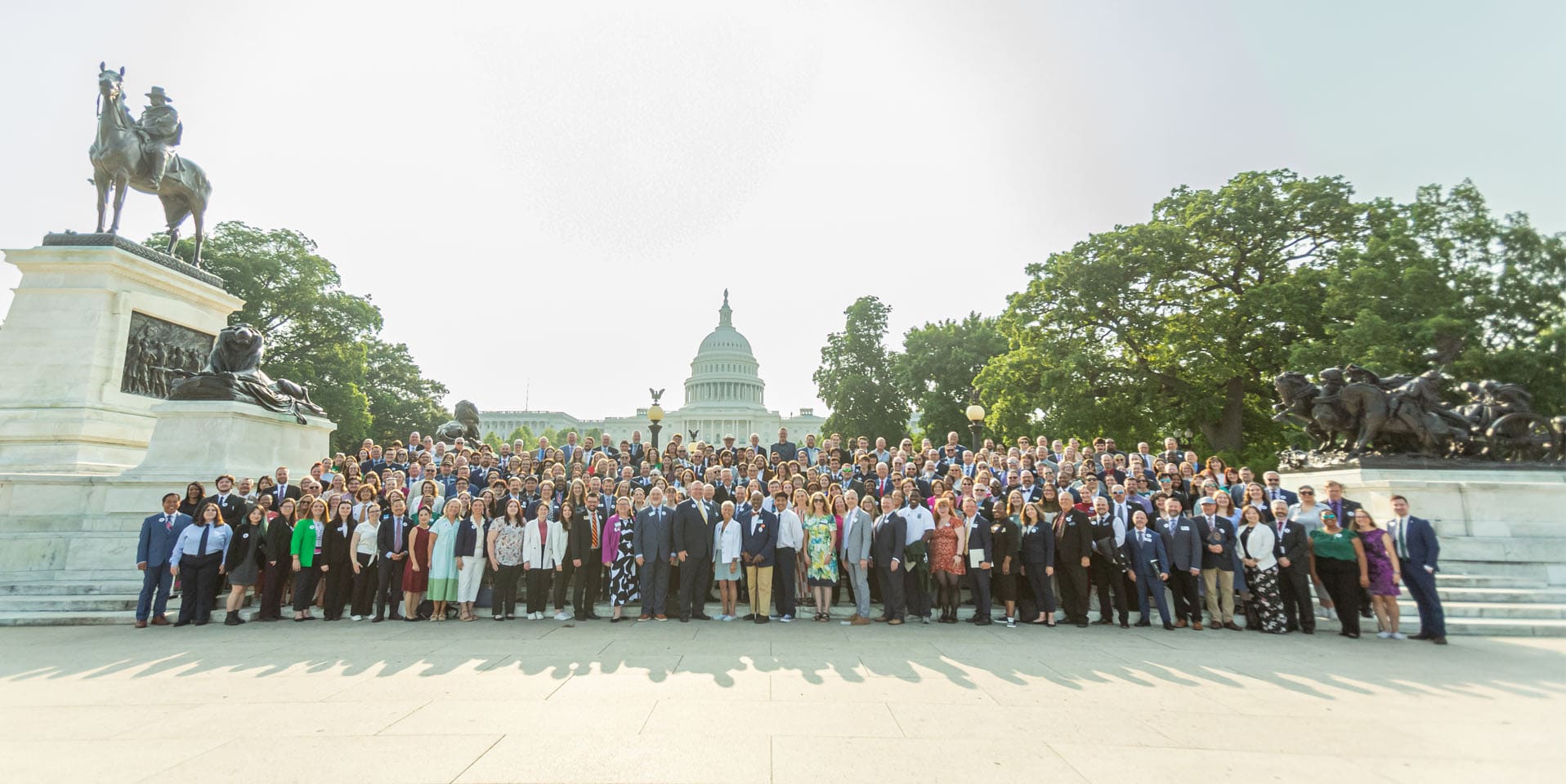 NAfME advocates stand together at Hill Day 2025 with the United States Capitol building in the background.