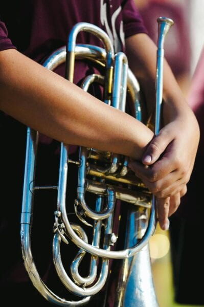 Closeup of student holding brass instrument