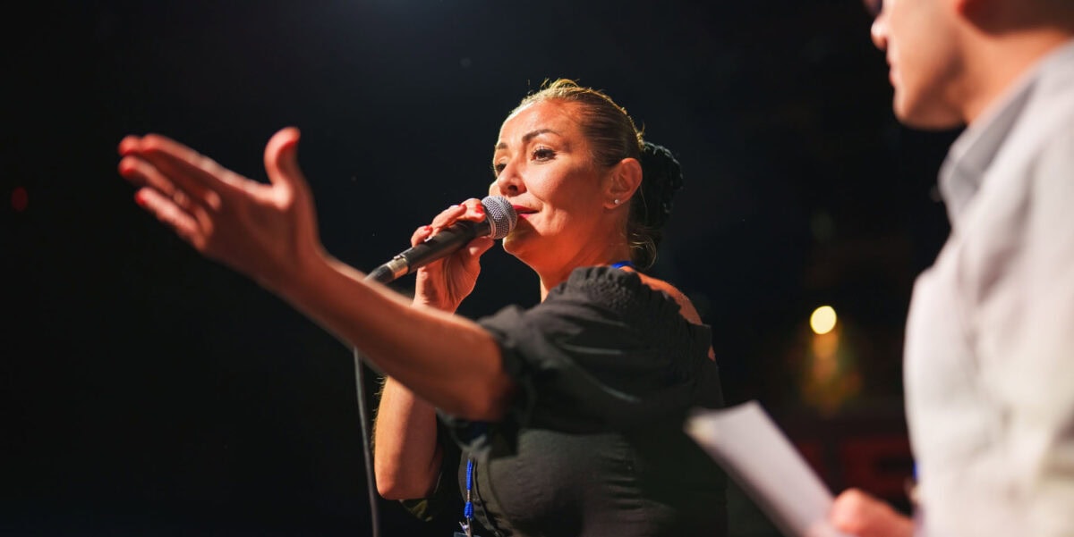 teacher talking to an audience with a microphone