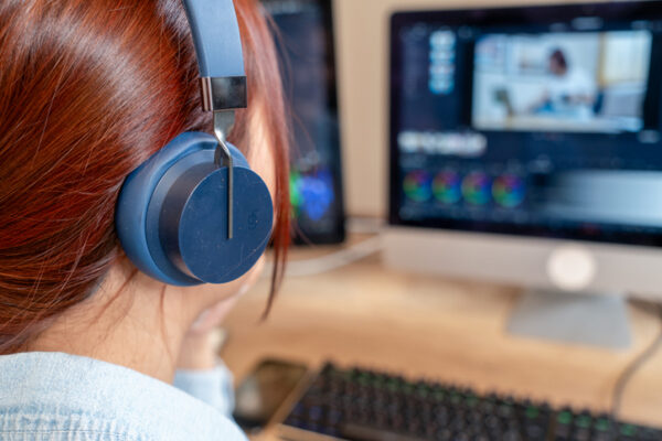 Female video editor works with footage and sound.