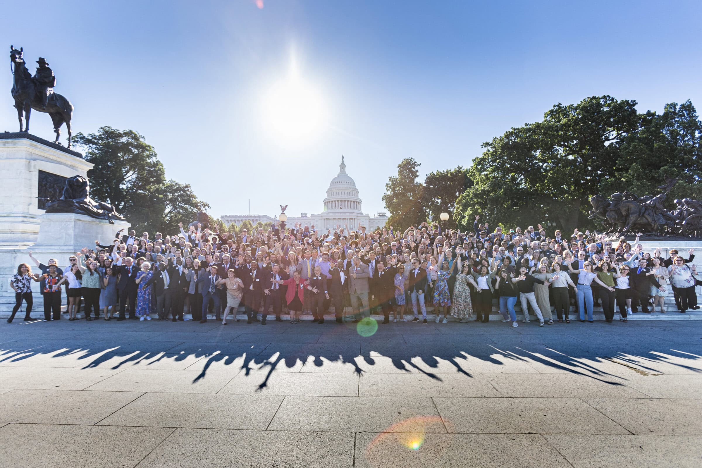 300 music education advocates pose for group shot on U.S. Capitol steps on a sunny day