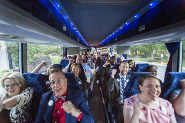 smiling passengers inside charter bus