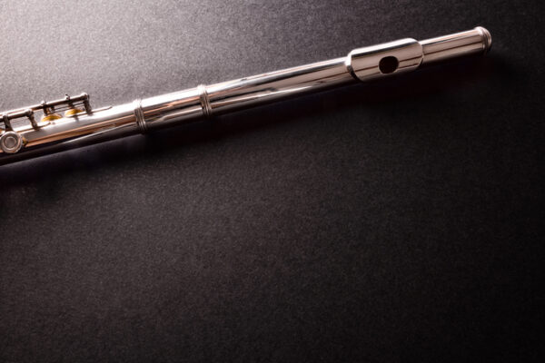 Top and mouthpiece of transverse flute on black table top
