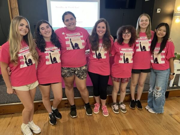 Group photo of students and counselors in Confidence Camp pink tshirts