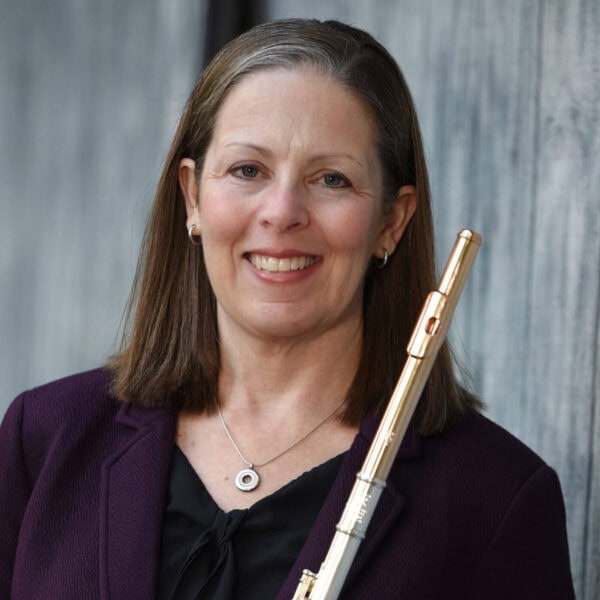 Kathleen Melago headshot holding flute